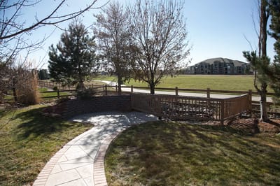 Outdoor landscaped area with walking path and trees