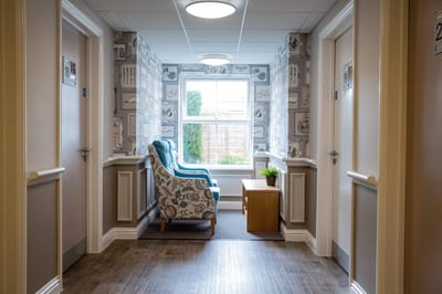 Hallway with chairs and windows in a living area