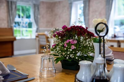 Decorative dining table with flowers and settings