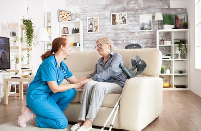 A caregiver interacting with a resident in a cozy living room
