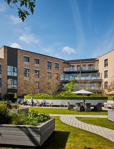 Exterior view of the care home with outdoor seating