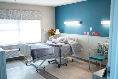 A well-furnished resident room in a nursing facility