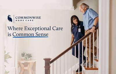 A caregiver assisting an older man on stairs