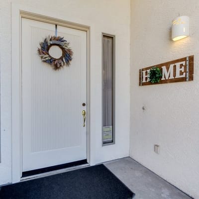 Front entrance decorated with a wreath and 'HOME' sign