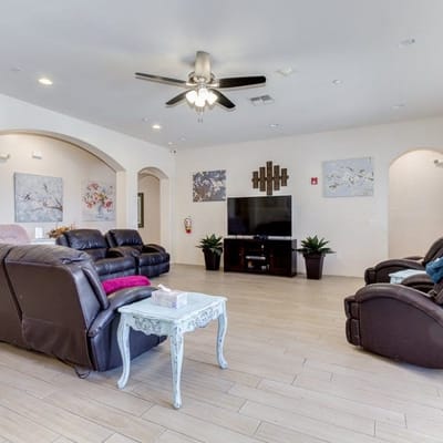 Bright common area with comfortable seating and TV