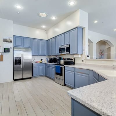 Modern kitchen interior with blue cabinets and appliances