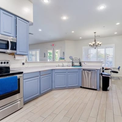 Bright and modern kitchen area with blue cabinets