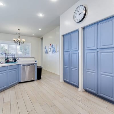 Bright, clean kitchen area with blue cabinets