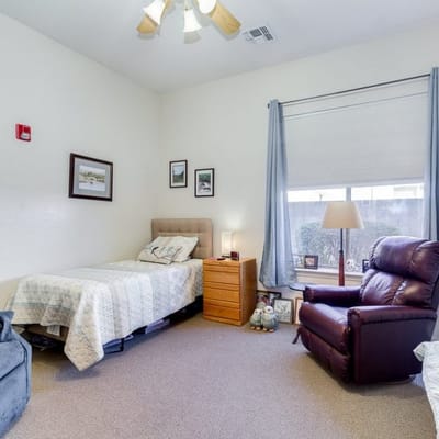 Cozy resident room with a bed and recliner
