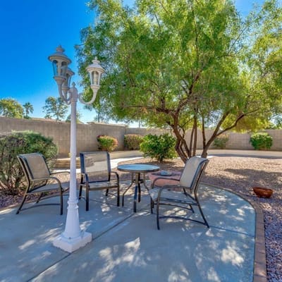 Outdoor seating area with trees and gravel landscaping