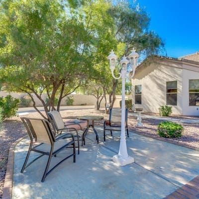 Outdoor seating area with trees and paths