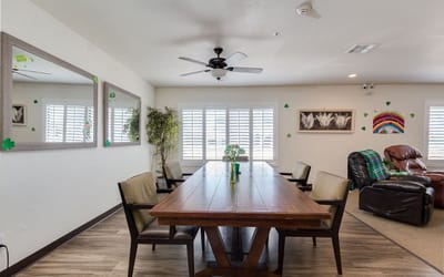 Bright common area with dining table and chairs