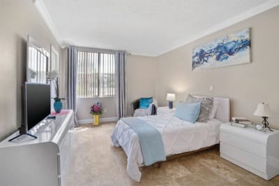 Bright resident room with a cozy bed and decor