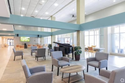 Bright common area with seating and a piano