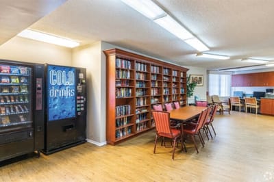 Interior view of a common area with bookshelves and seating