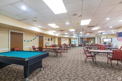 Interior view of an activity room with tables and chairs
