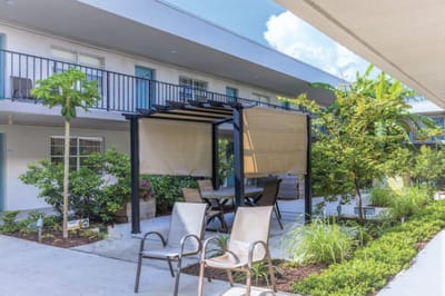 Outdoor seating area with a pergola and greenery