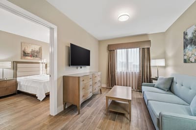 A bright, well-furnished resident room in a senior living facility