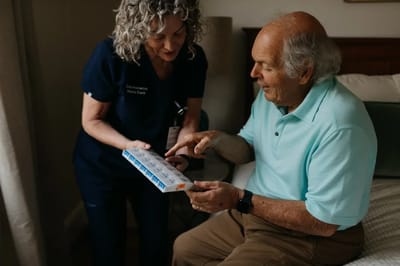 Staff assisting a resident with medication management