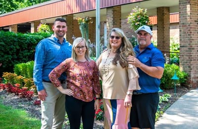 Residents with family in a vibrant garden area