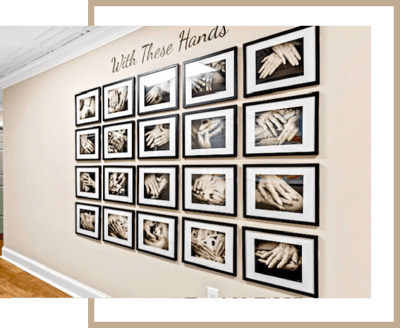 Gallery wall displaying framed pictures of hands