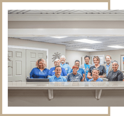 Staff posing in the reception area of the facility
