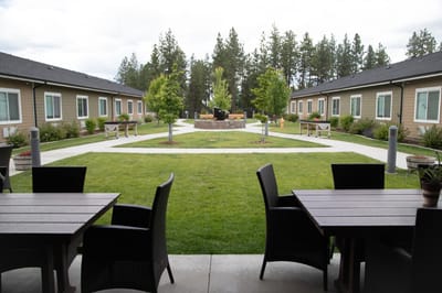 Close-up view of courtyard with tables and paths
