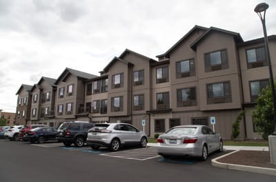 Exterior view of the facility building with parking lot