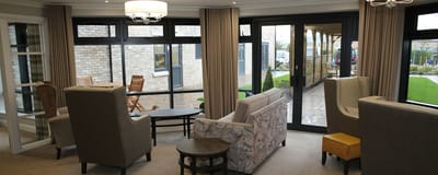 Bright common area with seating and large windows