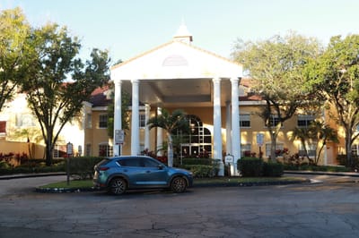 Exterior view of The Pointe at Plantation with entrance and landscaping