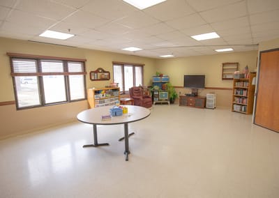 Bright common area with seating and shelves