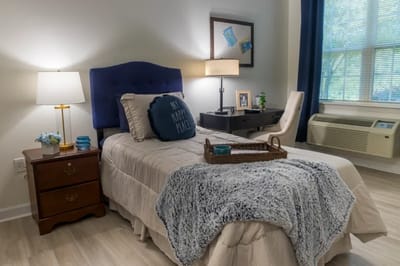 Cozy private resident room with bed and decor