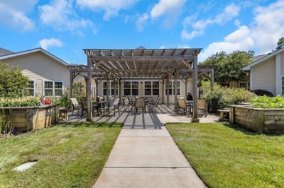 Outdoor patio area with seating and garden beds