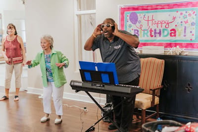 Residents enjoying a birthday celebration with live music