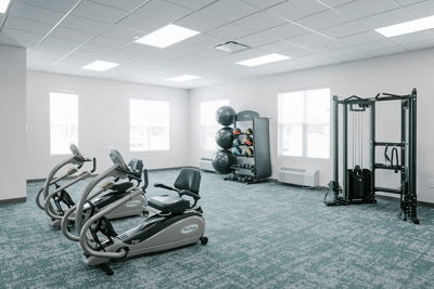 Well-equipped fitness room with exercise machines