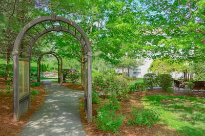 Pathway through a landscaped garden at a senior living facility