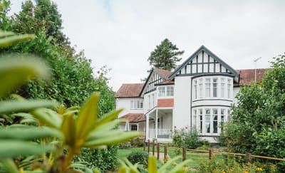 Exterior view of a residential home with gardens