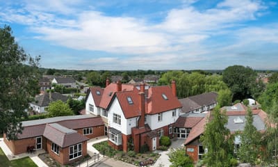 Aerial view of a residential care home surrounded by greenery