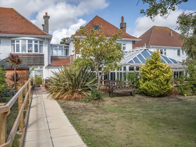 Exterior view of a residential home with garden pathways
