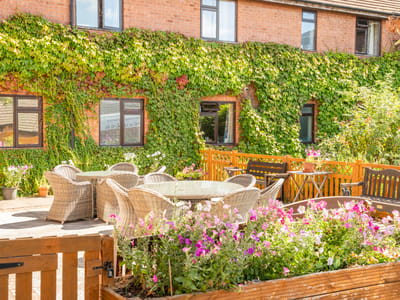 Outdoor patio area with seating and flowers