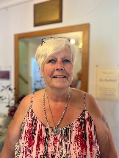 Resident smiling in a vibrant common area