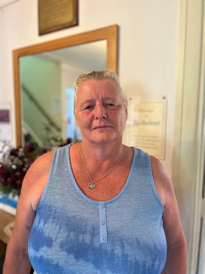 Staff member in a common area welcoming visitors