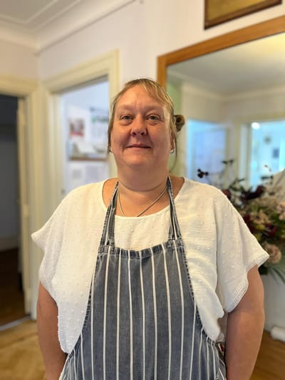 Staff member smiling in a care home environment