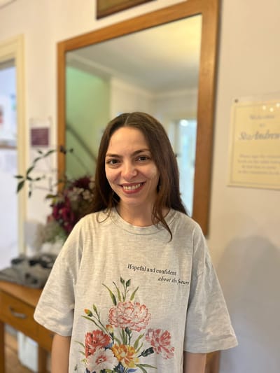 Staff member smiling in a facility interior