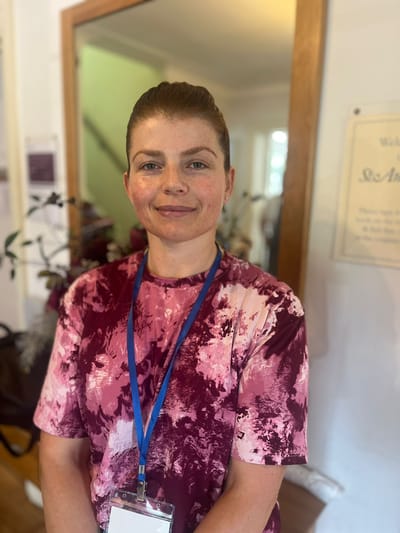 Staff member in a colorful shirt inside the facility