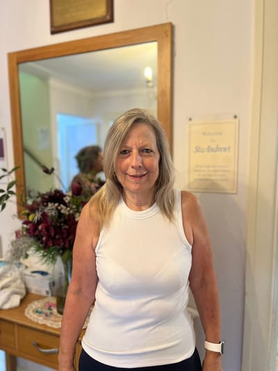 Female resident smiling in the facility's interior