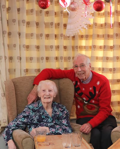 Senior couple sitting together in a cozy room