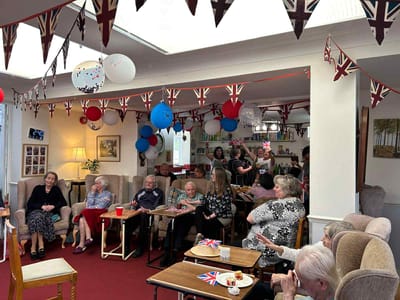 Residents and staff celebrating with decorations and food