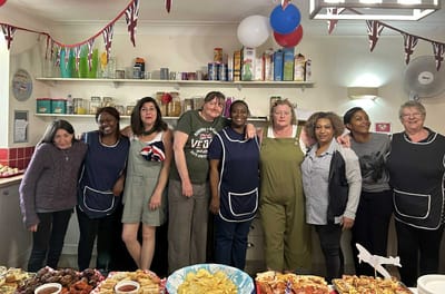 Staff and residents in a lively kitchen setting