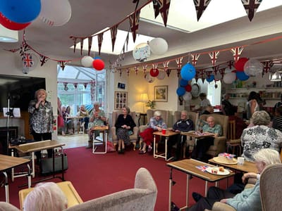 Residents enjoying an indoor activity with decorations